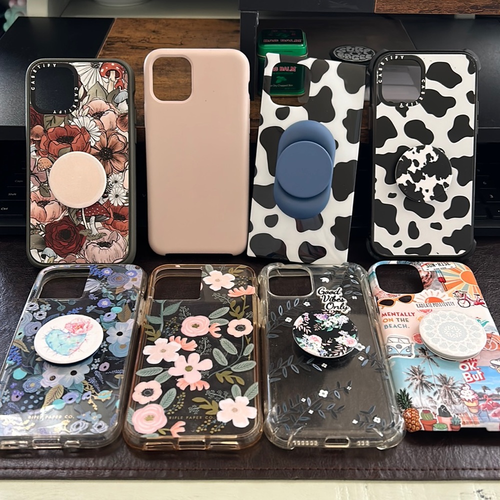 8 iPhone 11 Pro cases with pop sockets. Two Castify. Two rifle paper